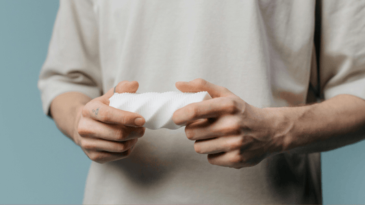 Close up shot of Man with beige shirt holding White Fleshlight
