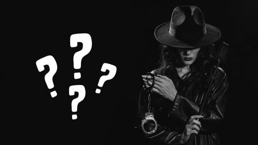 A woman wearing black leather and black hat holding cuffs an dkink padle in front of black background with four big white question marks next to her