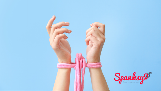 womans hands with pink bondage rope and light blue background giving off a happy comfortable vibe