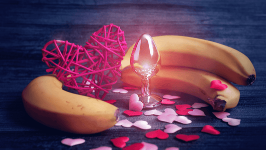 Valentines day hearts with three bananas circling adult toy