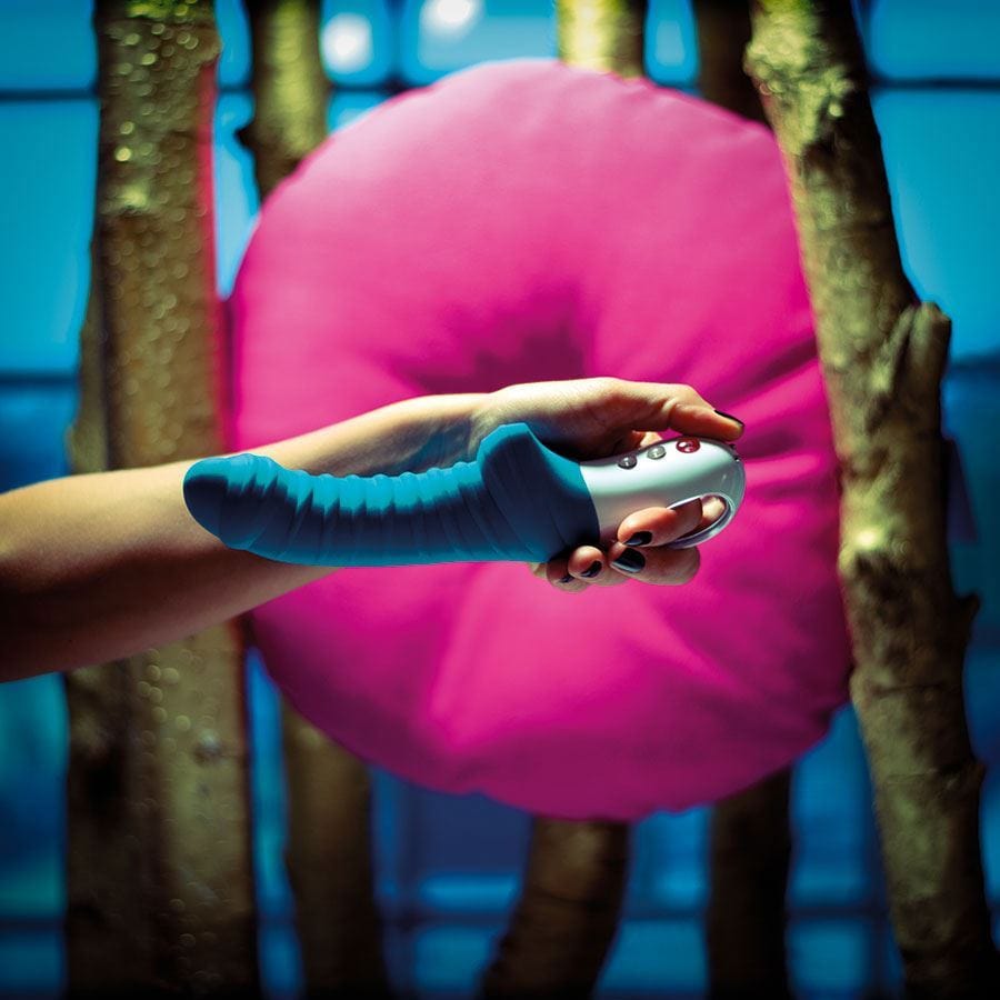 Three people each holding a vibrator over a pink background